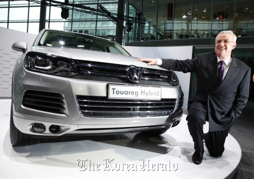 Martin Winterkorn, chief executive officer of Volkswagen AG, poses next to a Volkswagen Touareg Hybrid automobile during the company’s annual earnings news conference in Wolfsburg, Germany. (Bloomberg)