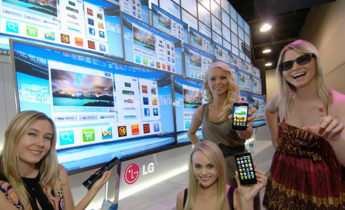 Models show LG Electronics’ smart TVs and smartphones Wednesday ahead of the opening of the Consumer Electronics Show in Las Vegas. (LG Electronics)