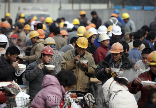 Workers gather for lunch at a makeshift eating area near a construction site in Shanghai. (Bloomberg)