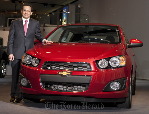 GM Daewoo president Mike Arcamone with the new subcompact car Chevrolet Sonic at the North American International Auto Show in Detroit on Monday. (GM Daewoo Auto and Technology Co.)