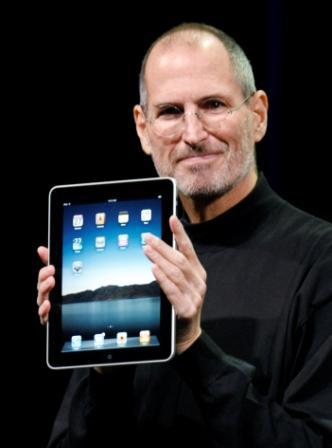 Apple CEO Steve Jobs is holding up the new iPad during a product announcement in San Francisco. Jobs sent a note Monday, Jan. 17, 2011 to employees saying he's taking a medical leave of absence so he can focus on his health. (AP-Yonhap News)