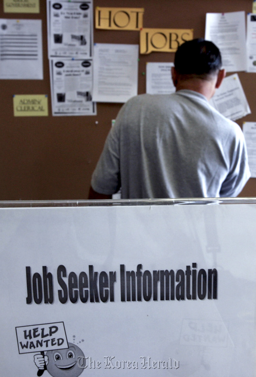 A job seeker looks at postings for jobs at the Verdugo Jobs Center in Glendale, California, United States. (Bloomberg)