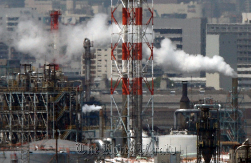 Steam rises from smokestacks at a factory in Kawasaki City, Kanagawa Prefecture, Japan. (Bloomberg)