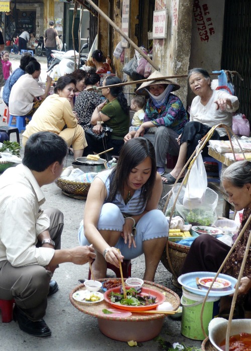 People eating at a stall in Old Quarter district in Hanoi, Vietnam. (AP-Yonhap News)