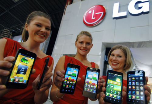 Models introduce LG Electronics’ new smartphones Revolution (left), Optimus 2X (center) and Optimus Black in Barcelona, Spain before the Mobile World Congress opens Monday. (LG Electronics)