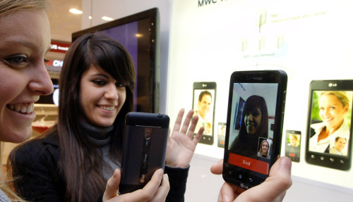 Models demonstrate LG Electronics’ Long-Term Evolution-based mobile phone at the Mobile World Congress in Barcelona. (LG Electronics)