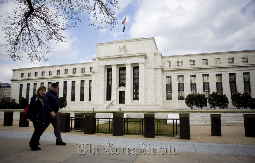 Pedestrians walk past the the Federal Reserve Building in Washington, D.C. (Bloomberg)