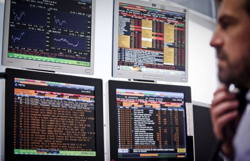 A trader looks at computer screens during trading in Lisbon. (AFP-Yonhap News)