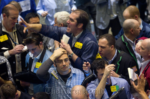 Traders work in the crude oil options pit at the New York Mercantile Exchange in New York. (Bloomberg)