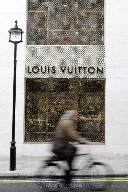 A cyclist passes a Louis Vuitton store on New Bond Street, in London. (Bloomberg)