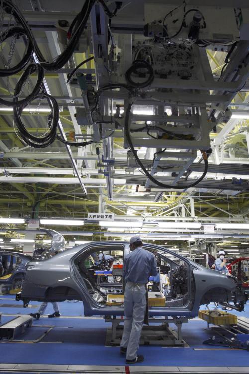 A worker assembles a Yaris compact sedan, for export to North America, on a new assembly line in Ohira in Miyagi Prefecture, northern Japan. (AP-Yonhap News)