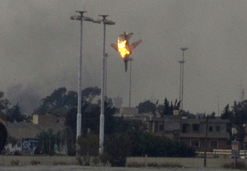 A warplane is seen being shot down over the outskirts of Benghazi, eastern Libya, Saturday. (AP-Yonhap News)