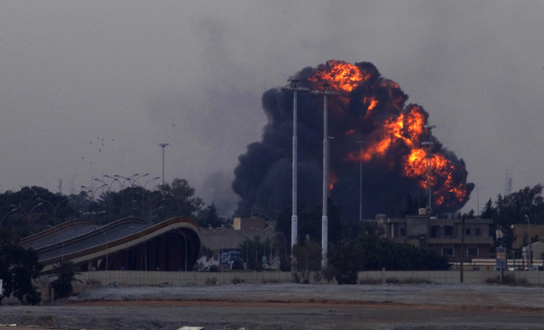 A huge explosion is seen over the outskirts of Benghazi after a warplane was shot down over Benghazi, eastern Libya, Saturday. (AP-Yonhap News)