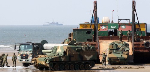 Military vehicles are unloaded from a barge on the west coast in Taean, South Chungcheong Province, Wednesday as part of a South Korea-U.S. joint amphibious logistic support exercise. (Yonhap News)