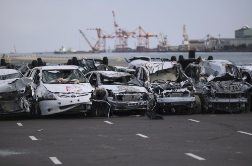 New vehicles damaged by the tsunami in a Toyota parking lot at Sendai port, Miyagi Prefecture, Japan, Monday. (AP-Yonhap News)