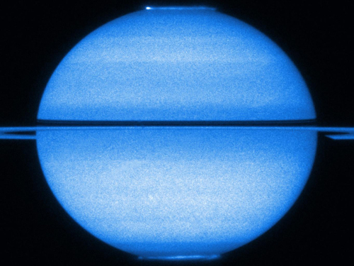 NASA/ESA's Hubble Space Telescope captures Saturn with the rings edge-on and both poles in view, offering view of its fluttering auroras on March 22, 2011. (NASA)