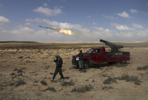 Libyan rebel fighters fire rockets in the desert half way between Ajdabiya and Brega, in Libya on Sunday. (AP-Yonhap News)