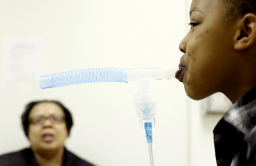 Cedarian Stuart-Payne, 12, gets breathing treatment due to problems from allergies as his mother Calandra Stuart looks on at the allergy clinic at the Henry Ford Medical Center in Dearborn, Michigan. (Sarah Rice/Detroit Free Press/MCT)