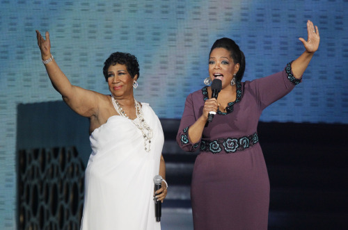 Aretha Franklin and Oprah Winfrey acknowledge fans. (AP)