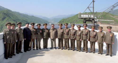 North Korean leader Kim Jong-il (eighth from left) and his son and heir apparent Jong-un (fourth from left) pose with officials during his recent visit to the Heechun Power Plant construction site in Jagang Province. (Yonhap News)