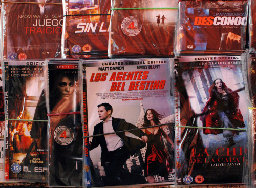 A street stall in Mexico City offers more than 200 pirated movie titles, including new Hollywood releases for just 15 pesos, or about $1.30. Inside the Sanborns department store next door, original titles can cost as much as 280 pesos, or about $24. (Lauren Villagran/Dallas Morning News/MCT)