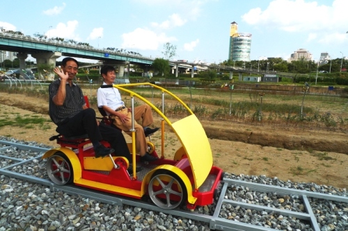 People ride rail bikes at Gwangnaru Han River Park in Seoul. (The Hangang Project Headquarters)