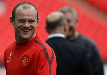Manchester United's English forward Wayne Rooney smiles during a training session on the eve of the UEFA Champions League final football match FC Barcelona vs. Manchester United, on May 27, 2011 at Wembley stadium in London. (AFP)
