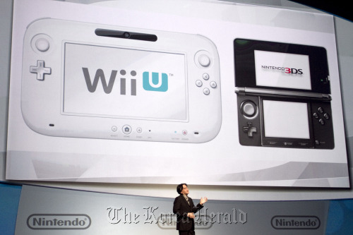 Satoru Iwata, president of Nintendo Co., introduces the Wii U video-game handheld console during a presentation at the Electronic Entertainment Expo in Los Angeles on Tuesday. (Bloomberg)