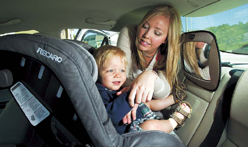 Sarah McIntosh buckles Ethan McIntosh, 13 months, into his car seat in Kansas City, Missouri. (Shane Keyser/Kansas City Star/MCT)