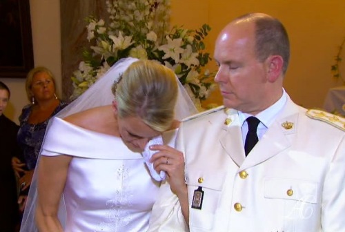 Charlene Princess of Monaco is wiping a tear from her eye during the wedding service in the chapel of the Sainte Devote Church to Prince Albert II of Monaco (right) Saturday, 2011. (AP-Yonhap News)