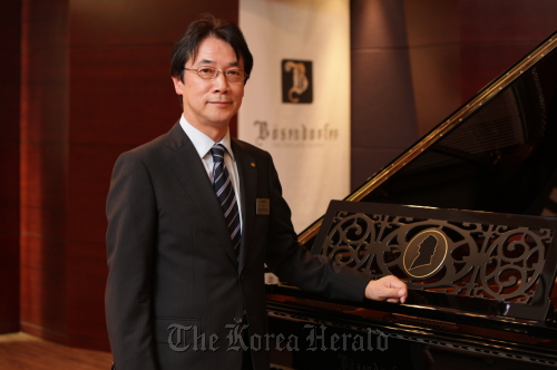 Hitoshi Fukutome, president of Yamaha Music Korea, stands next to a Bösendorfer piano at a Yamaha showroom in southern Seoul on Thursday. (Yamaha Music Korea)