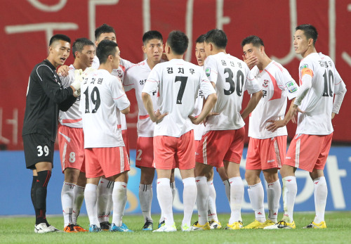 Sangju Sangmu players gather in midfield during a match on July 9. (Yonhap News)