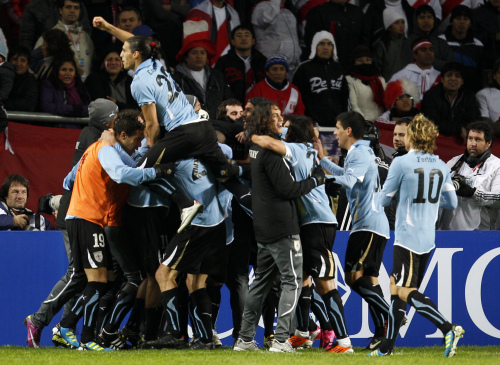 Uruguay players celebrate after beating Peru. (AP-Yonhap News)