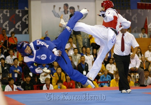 A Korean athlete (left) competes against an athlete from Russia in the five-member kyorugi team final match at the World Poomsae Championships in Vladivostok, Russia, Saturday. (WTF)