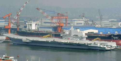 A Chinese aircraft carrier at anchor at Dalian port in northeast Liaoning province. (AP-Yonhap News)