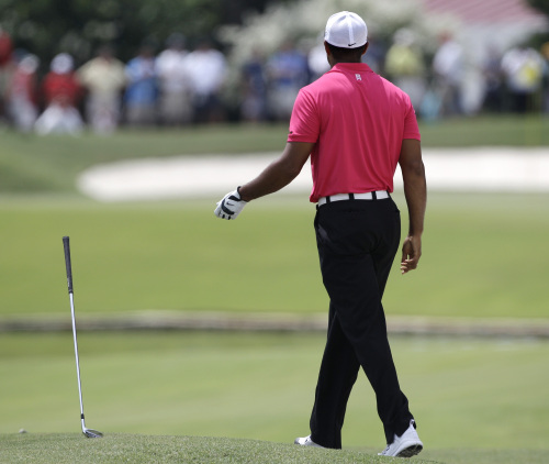 Tiger Woods flips his club after hitting out of a bunker on the sixth hole during the first round of the PGA Championship at the Atlanta Athletic Club in Johns Creek, Georgia on Thursday. (AP-Yonhap News)