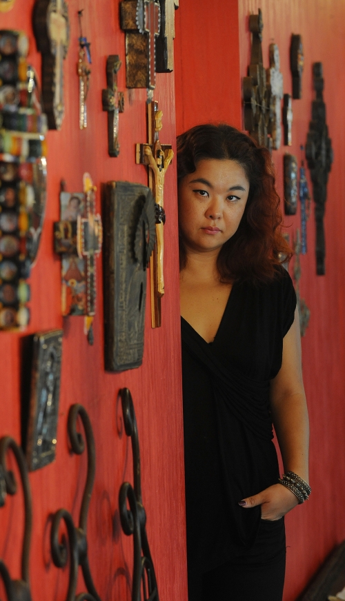Lee Ju-young at her shop, decorated with artwork inspired by Medieval Christian art, in Sinsa-dong, southern Seoul. (Lee Sang-sub/The Korea Herald)