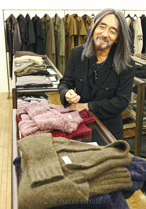 Fashion designer Yohji Yamamoto poses for a recent portrait with his line of clothes. (Yomiuri Shimbun/MCT)