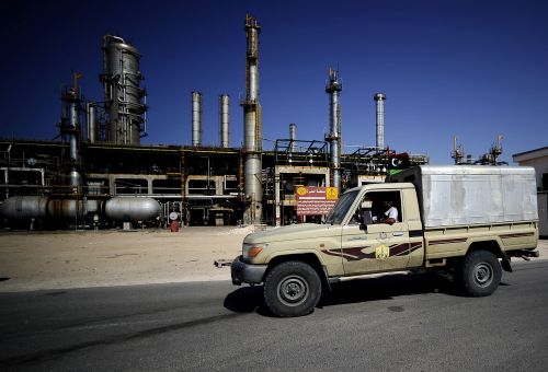 Libyan rebels drive past the Zawiya oil refinery, some 40 km west of Tripoli, on Friday. (AFP-Yonhap News)