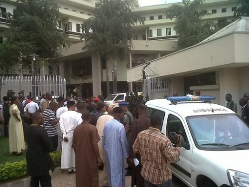 This image released by Saharareporters shows ambulances and rescue workers after a large explosion struck the United Nations' main office, background, in Nigeria's capital Abuja Friday, flattening one wing of the building and killing several people. A U.N. official in Geneva called it a bomb attack. The building, located in the same neighborhood as the U.S. embassy and other diplomatic posts in Abuja, had a huge hole punched in it. (AP)