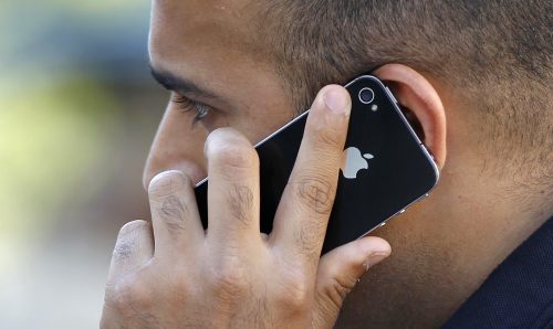 A man uses an Apple iPhone.