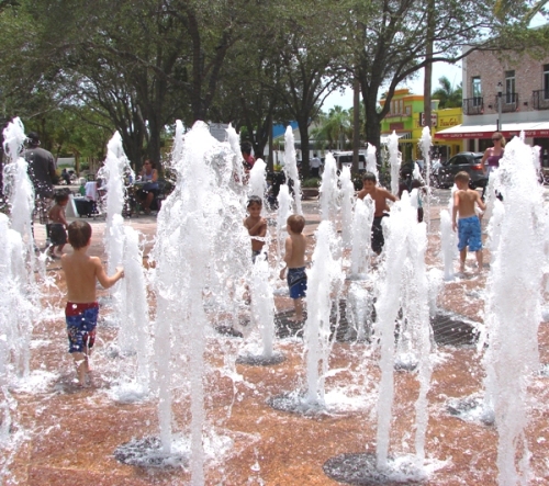 Kids keep cool by splashing in the fountain at the waterfront park in West Palm Beach, Florida. (MCT)
