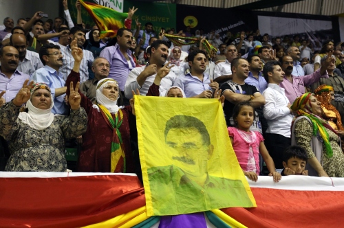 Supporters of the pro-Kurdish party wave a poster of jailed Kurdish rebel leader Abdullah Ocalan in Ankara on Sunday. (AP-Yonhap News)