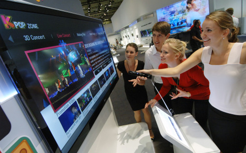 People try out LG Electronics’ 3-D television based on the passive glasses technology at IFA 2011 last week. (LG Electronics)