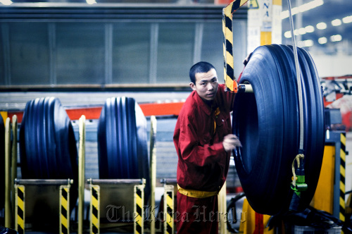 A factory worker produces tires at the Pirelli & C SpA tire factory in Jining, Shandong Province, China. (Bloomberg)