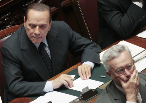 Italian Premier Silvio Berlusconi (left) looks on prior to the start of a voting session in parliament on the government's austerity package in Rome on Sept. 14.(AP-Yonhap News)