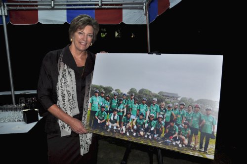 U.S. Ambassador Kathleen Stephens poses next to a poster showing the embassy’s bicycle squad that traveled to many parts of the country. (Yoav Cerralbo/The Korea Herald)