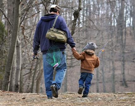 A father and son head for their fishing hole at Muddy Run Recreation Park in southern Lancaster County, Pennsylvania New research suggests that dads are less likely to die of heart-related problems than childless men are. (AP)