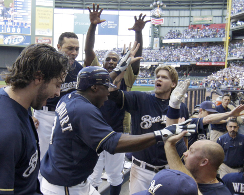 Milwaukee Brewers shortstop Yuniesky Betancourt (center) is congratulated after hitting a two-run home run in the fifth inning. (AP-Yonhap News)