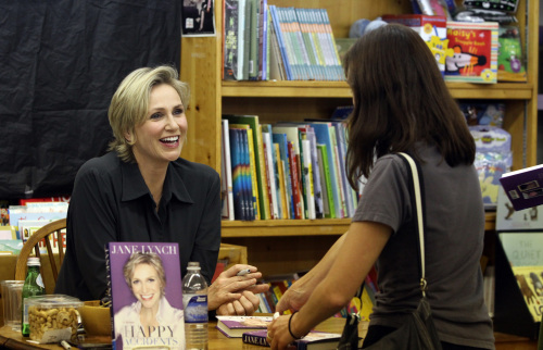 Actress and now book author Jane Lynch, left, one of the stars of the TV show “Glee,” signs copies of her new memoir, “Happy Accidents,” at Women and Children First bookstore in Andersonville neighborhood of Chicago, Illinois, on Oct. 9. (Chuck Berman/Chicago Tribune/MCT)